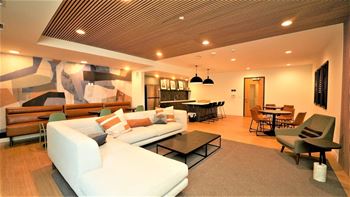 a large living room with a white couch and a table